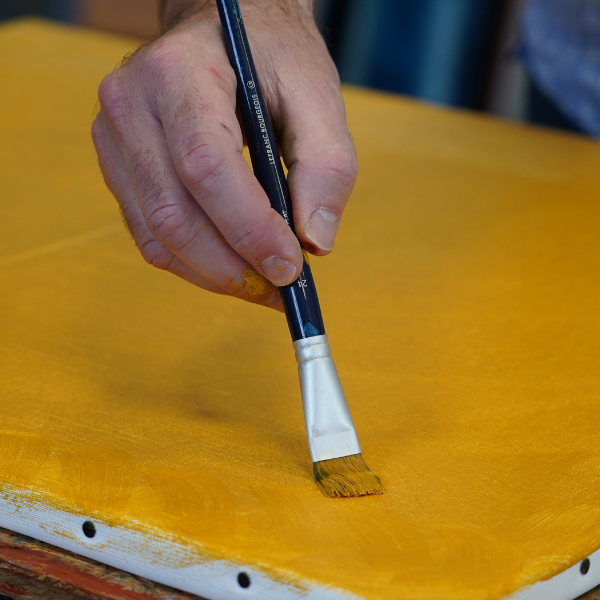 preparing a canvas with acrylic paint