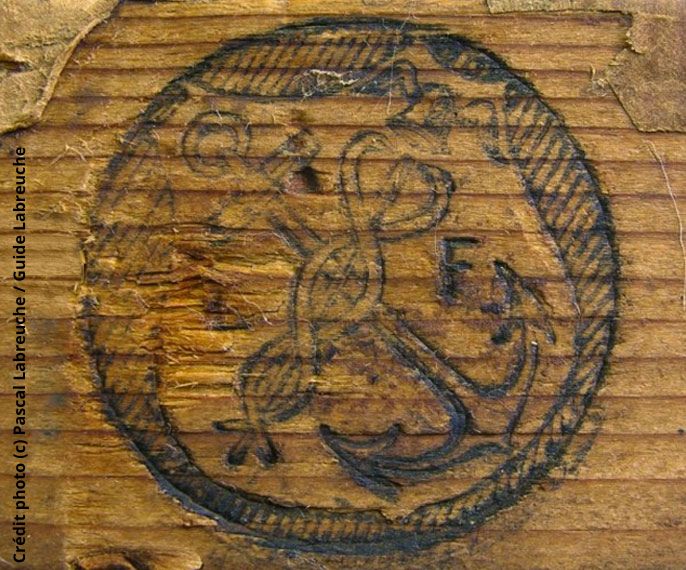 logo anchor and caduceus, on wood